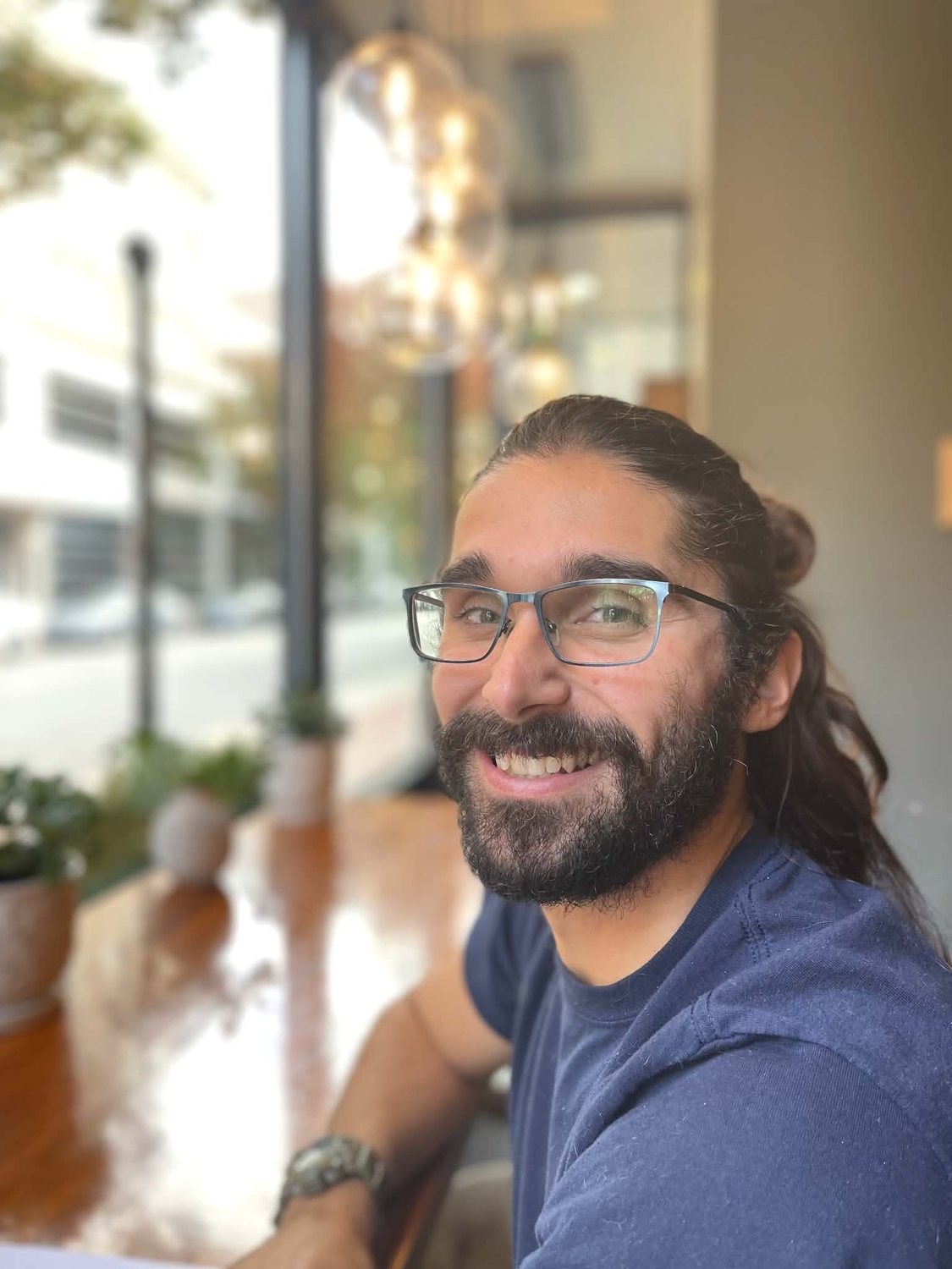Ozan Duran smiling indoors