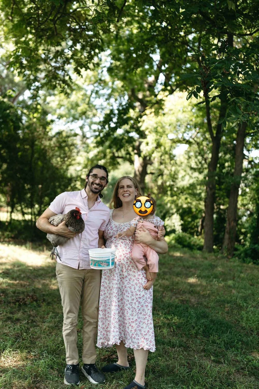 Ozan Duran with his family holding a chicken outdoors
